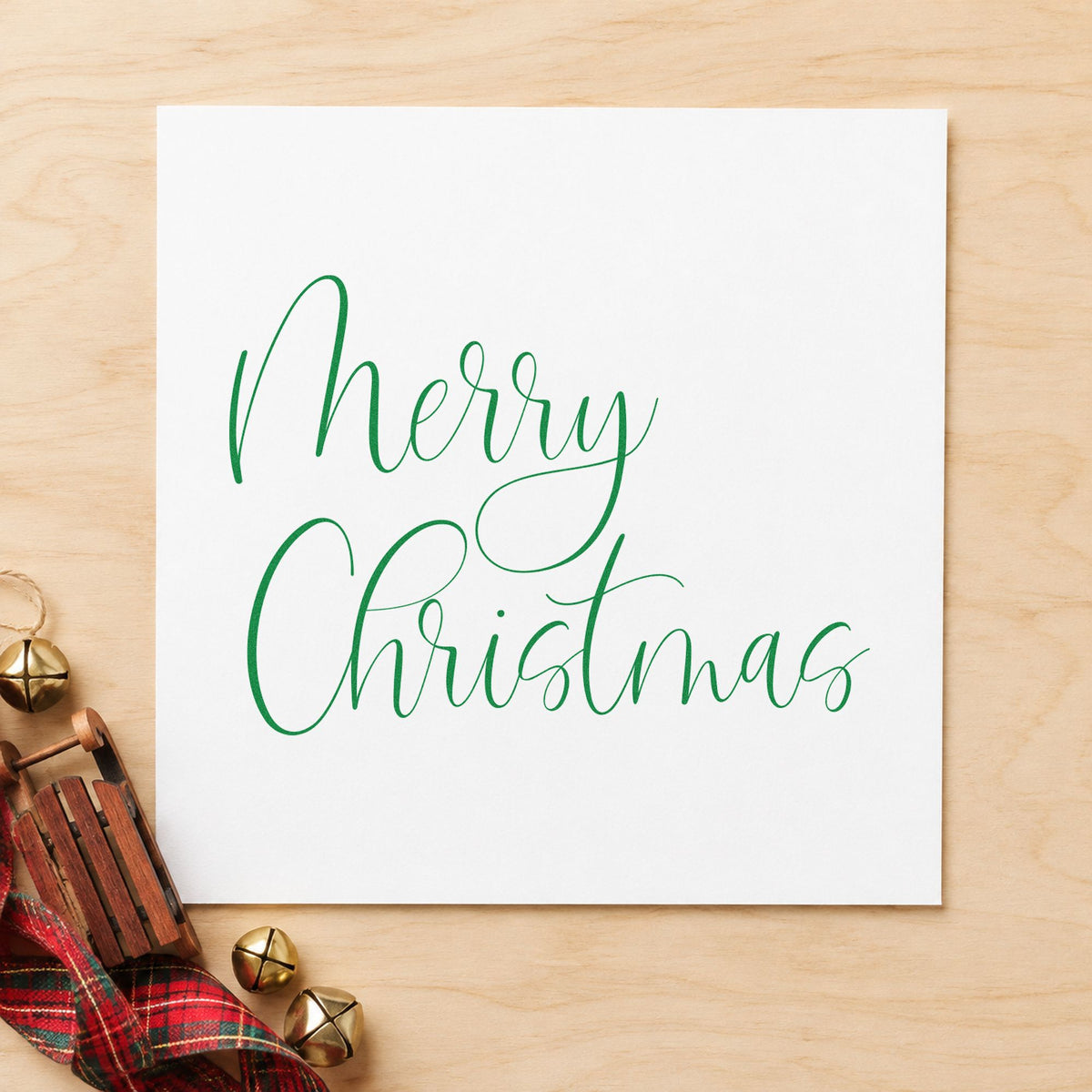 Merry Christmas Airy Calligraphy craft stamp imprint in green ink on a handmade project, one idea being minimal table slips.