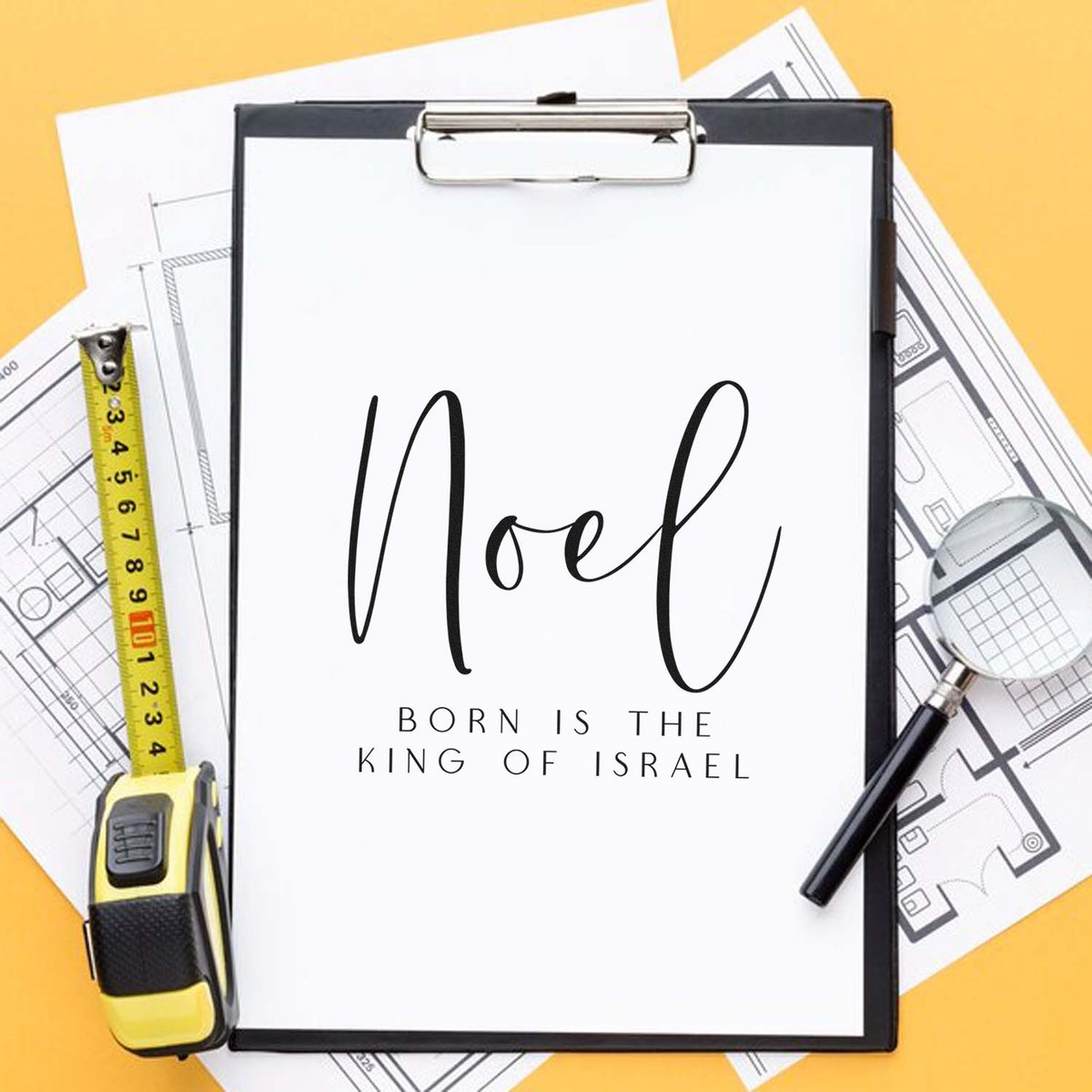 Black custom stamp and seal on a white clipboard, with Noel lettering, tape measure, magnifier, and blueprints on a yellow background.