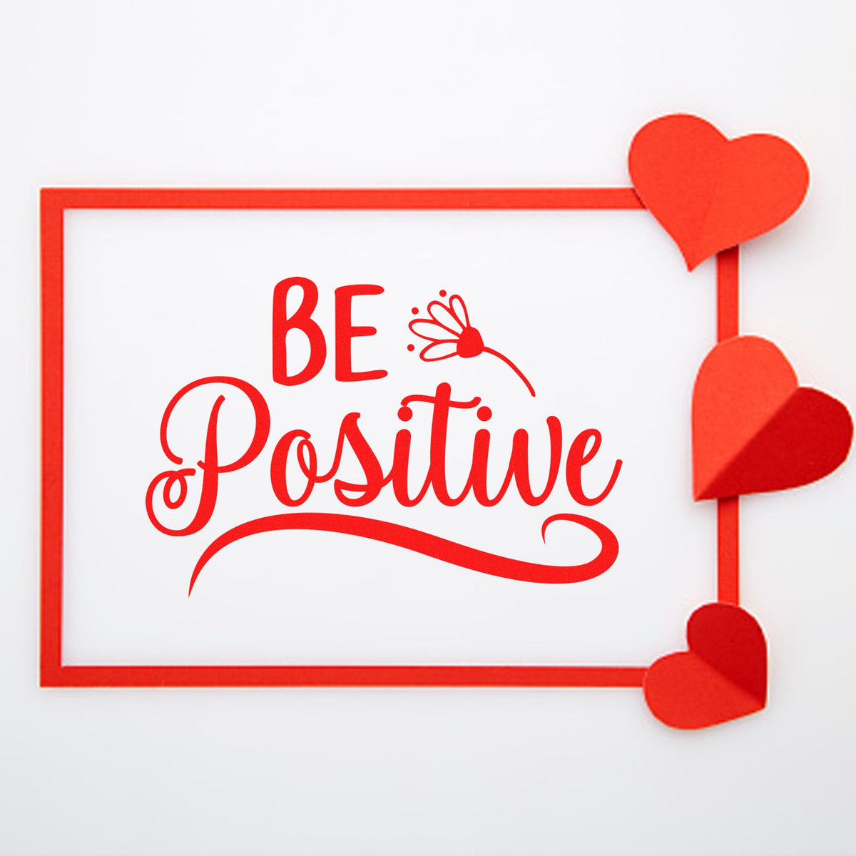 Red Be Positive stamp and seal design with heart accents on a white background