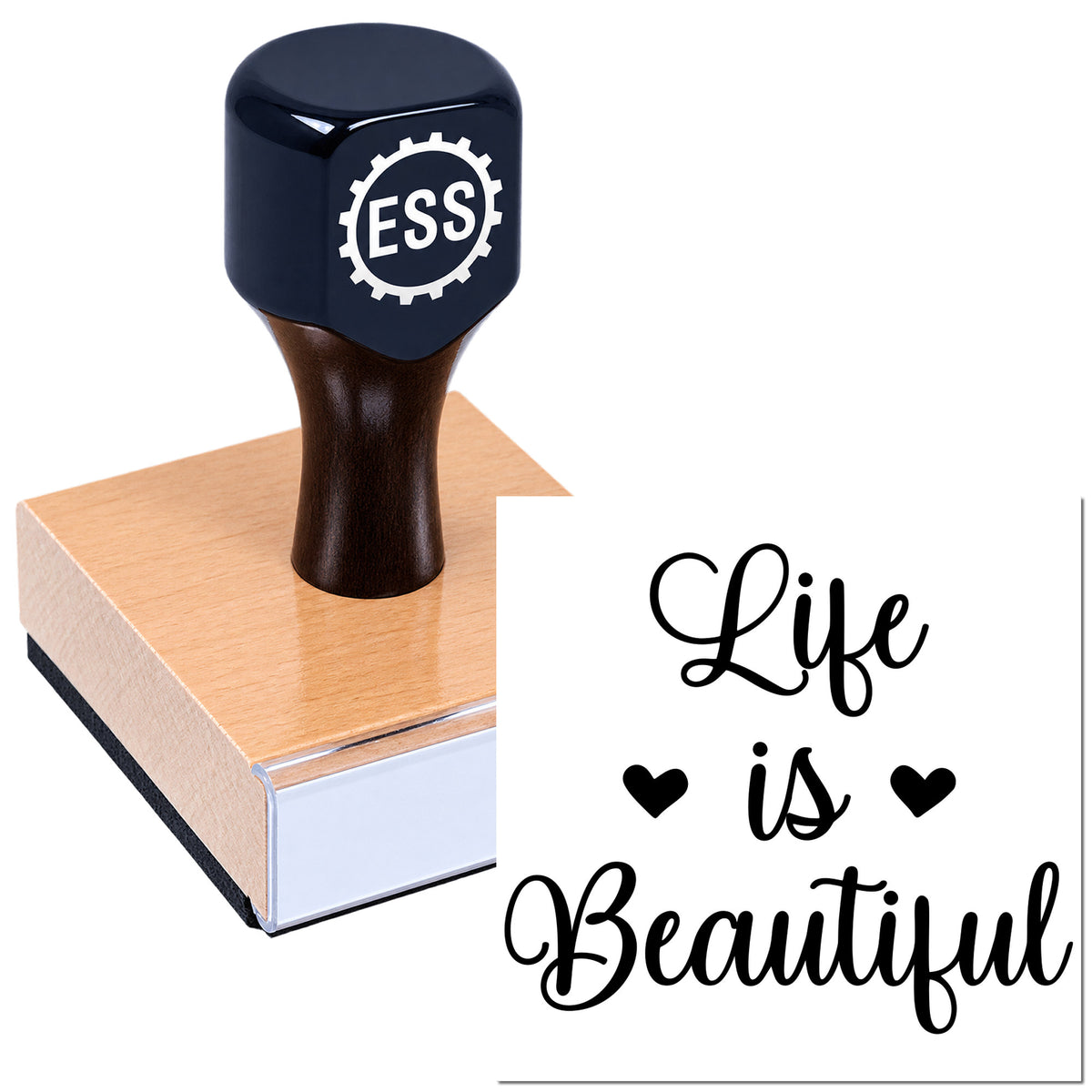 Black rubber stamp with ESS gear logo on wooden seal block, printing "Life is Beautiful" with hearts.