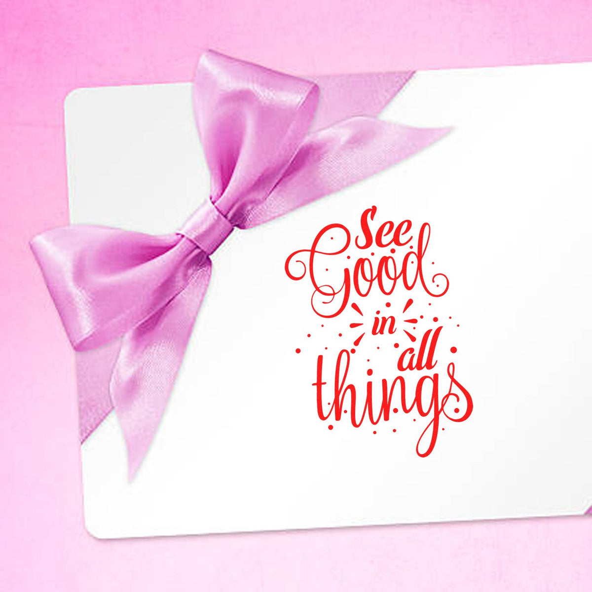 Pink ribbon bow on white card with red See Good in All Things decorative stamp seal.