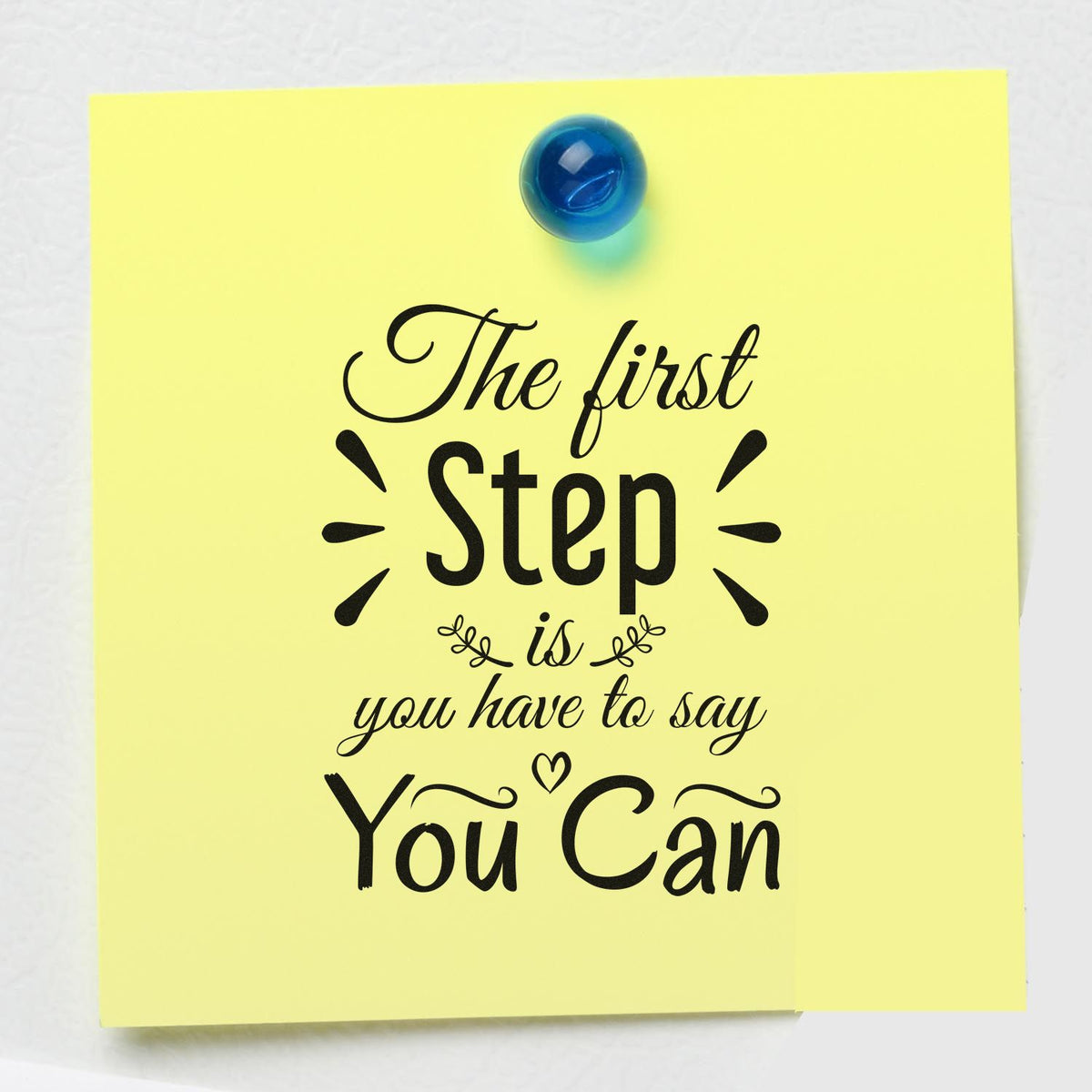 Yellow stamp seal design with black motivational quote and blue pushpin.