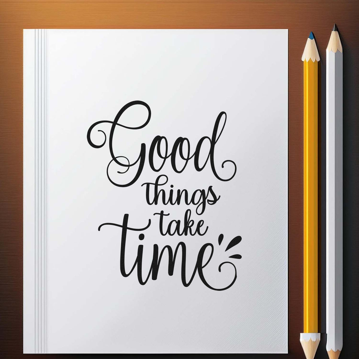 Stamp and seal product design with black script Good things take time on white paper, beside yellow and white pencils.