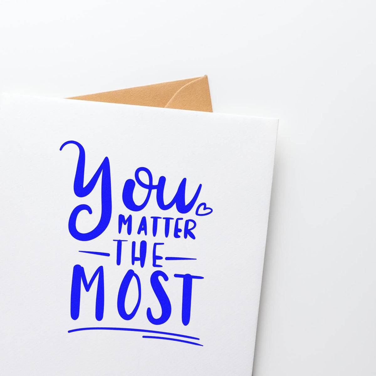 Blue stamp and seal reading You Matter The Most on a white card with tan envelope.