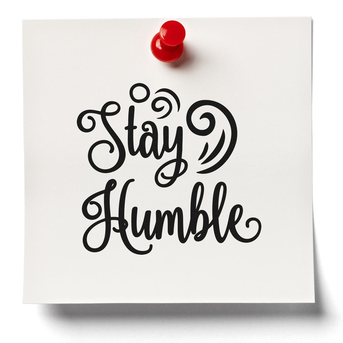 Black Stay Humble decorative stamp on white card, topped with a bright red seal pushpin.