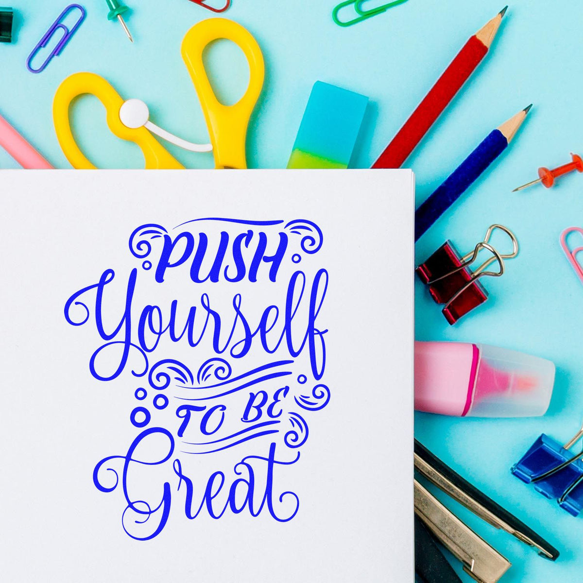 Custom stamp and seal with blue Push Yourself to Be Great lettering, on turquoise background with colorful office supplies.