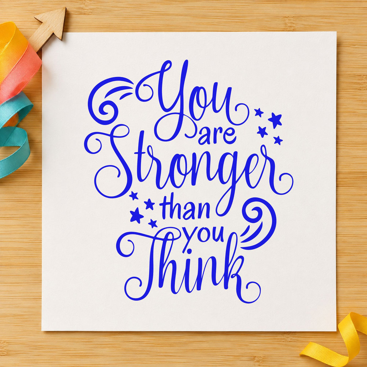 Stronger Than You Think craft stamp in blue ink on cardstock, an easy option for arm sleeve printing.