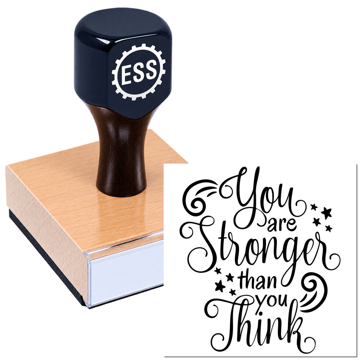 Dark blue ESS stamp and seal on a wood block, with black script reading "You are stronger than you think."