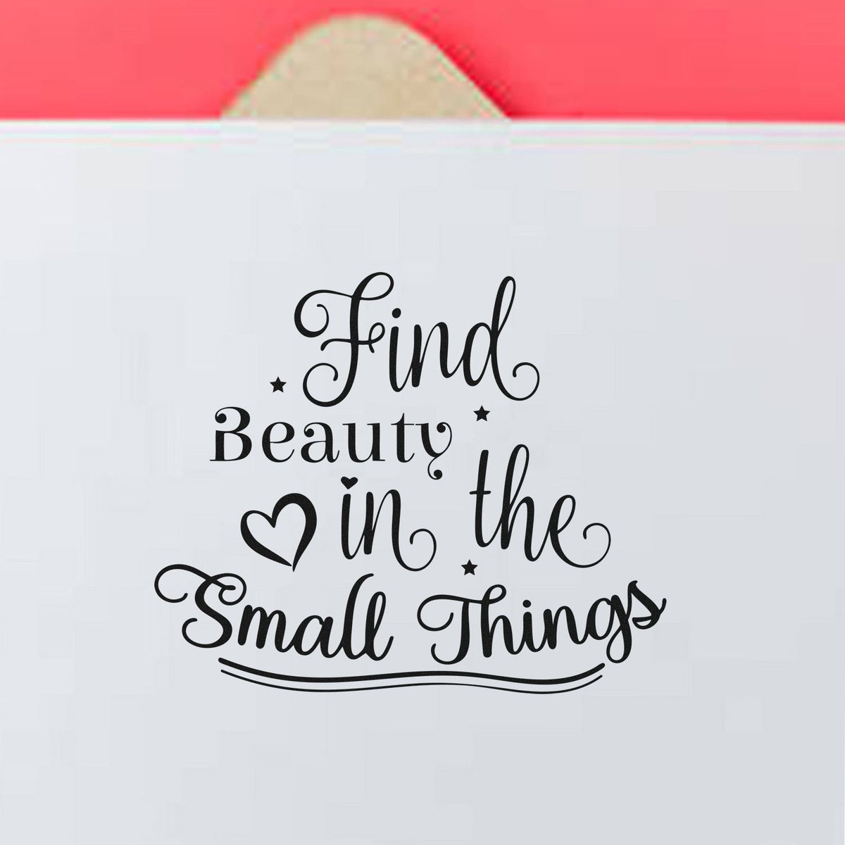 Black decorative stamp seal reading Find Beauty in the Small Things on white packaging with a pink top tab.