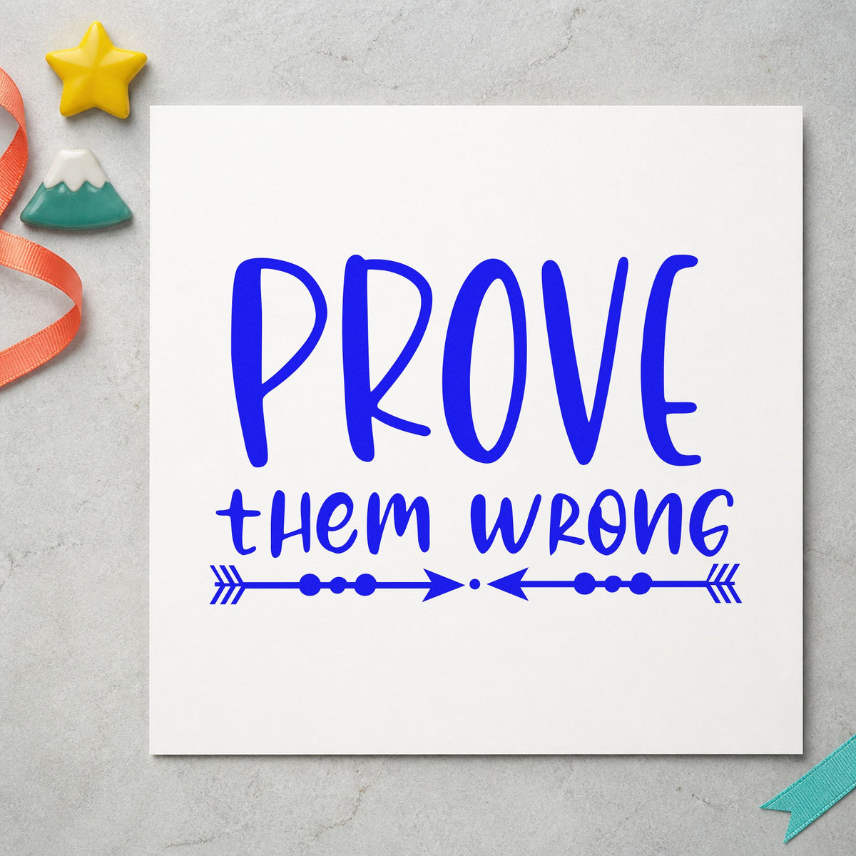 Prove Them Wrong Arrows craft stamp in blue ink on cardstock, an easy option for hoodie back printing.