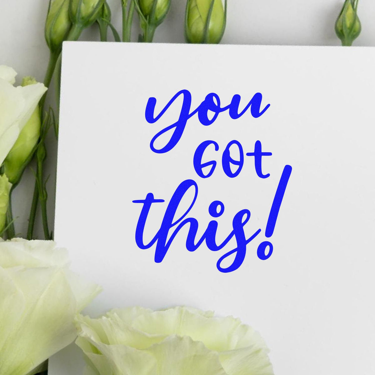 Custom blue stamp/seal reading you got this! on white card with white flowers and green buds.