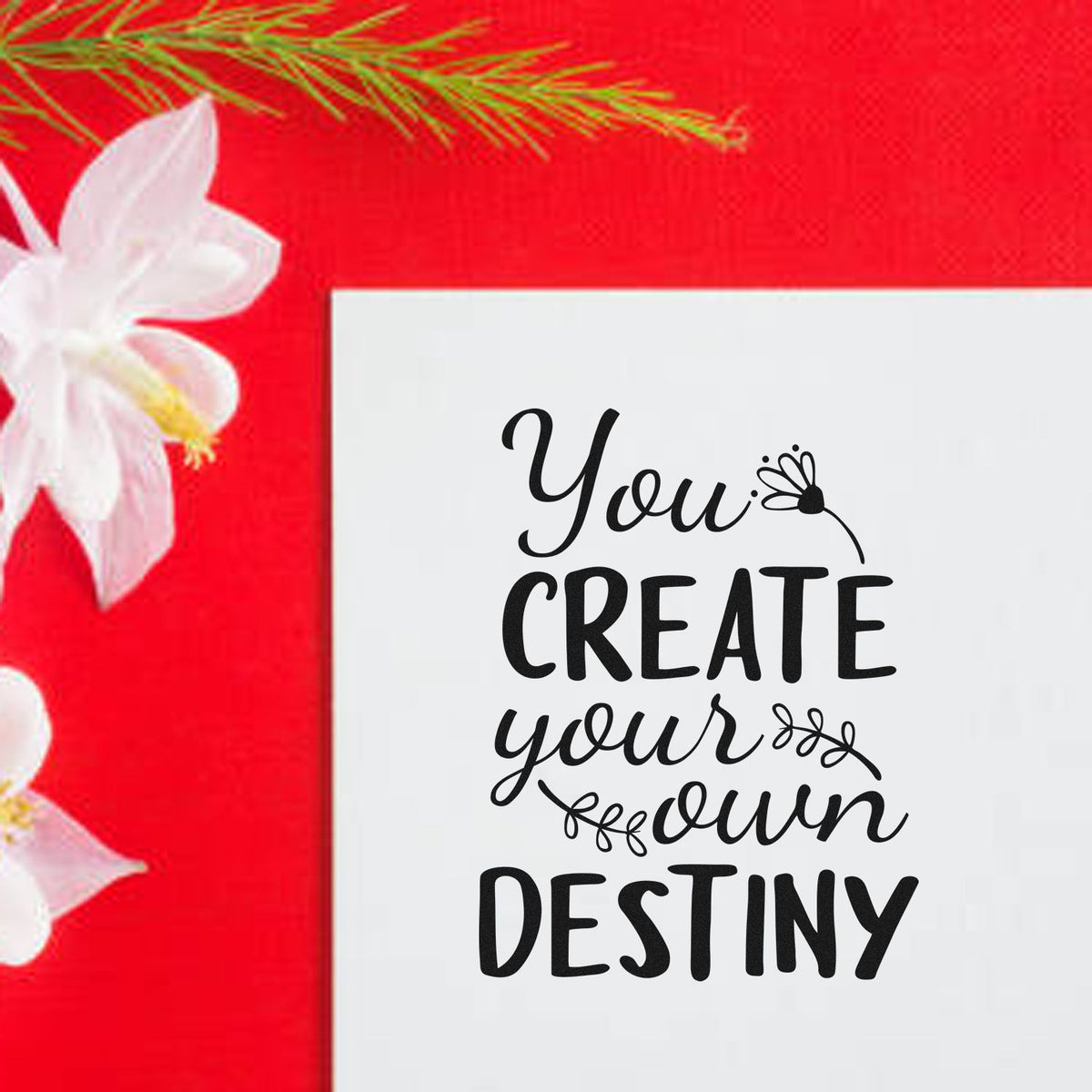 Custom stamp and seal with black You create your own destiny text on white, set against a bright red floral background.