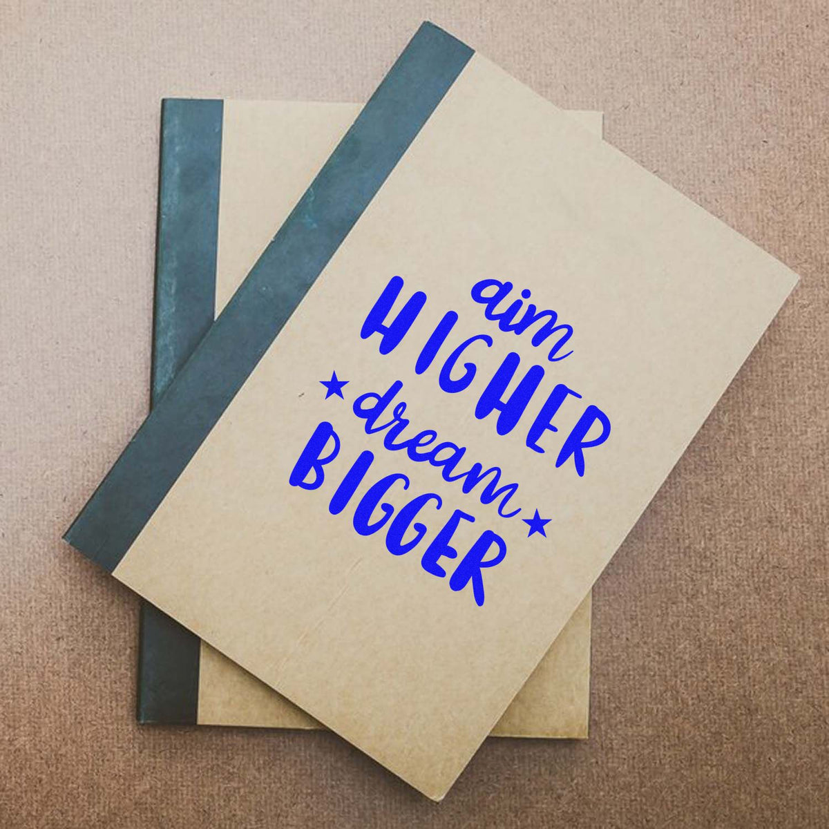 Cream stationery with teal spines and a blue custom stamp seal reading Higher Dream Bigger