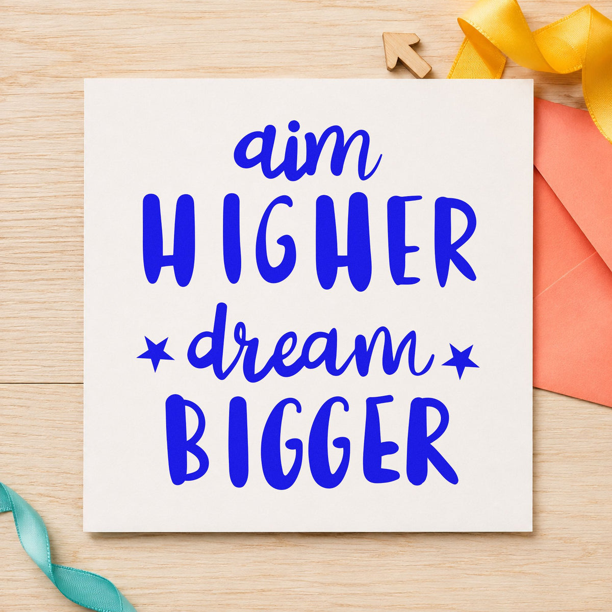 Aim Higher Dream Bigger craft stamp imprinted in blue ink on paper, a design suited to framed club room.