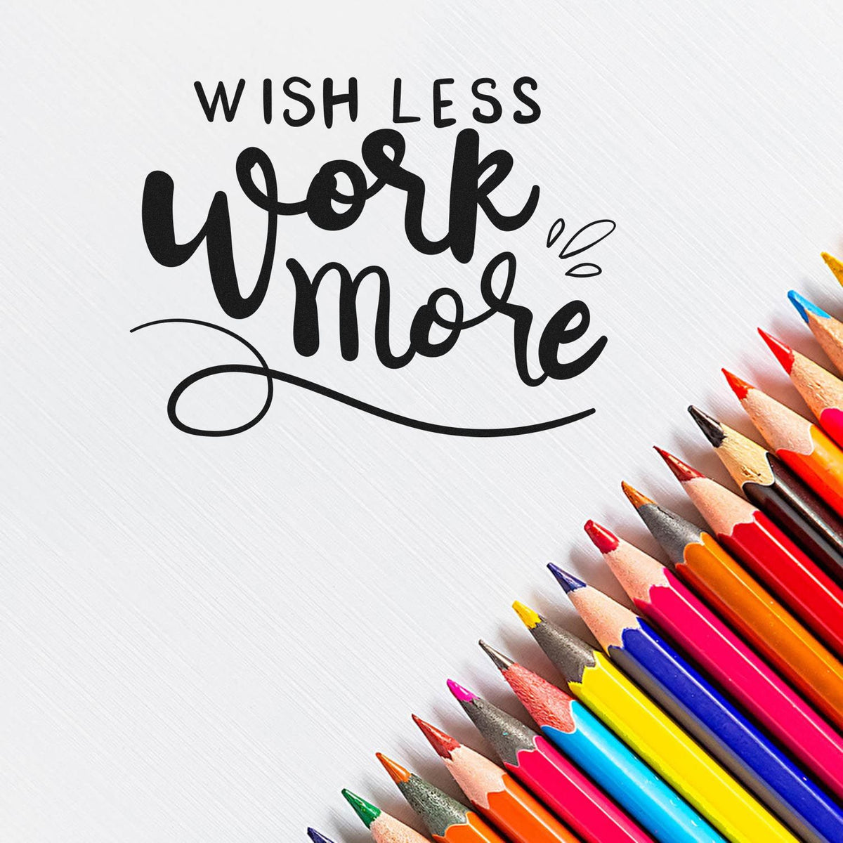 Black Wish Less Work More stamp and seal design on white background with colorful pencils along the edge