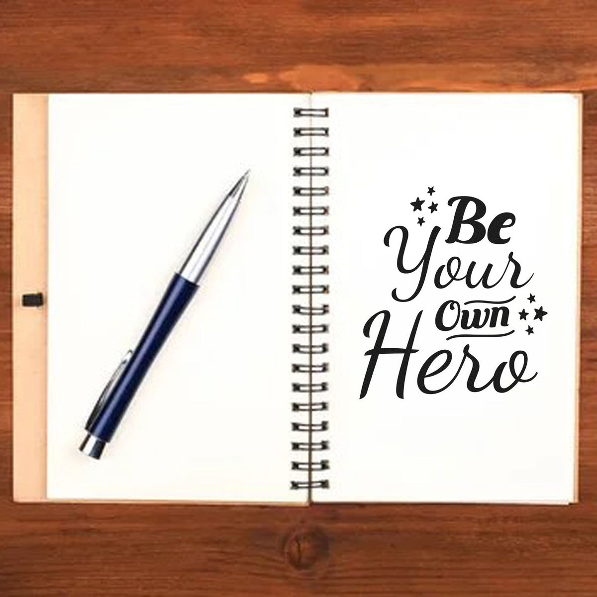 Vintage Pro Be Your Own Hero Premium Wooden Stamp imprint stamped in black ink. The phrase "Be your own hero" appears in bold decorative script with star clusters.