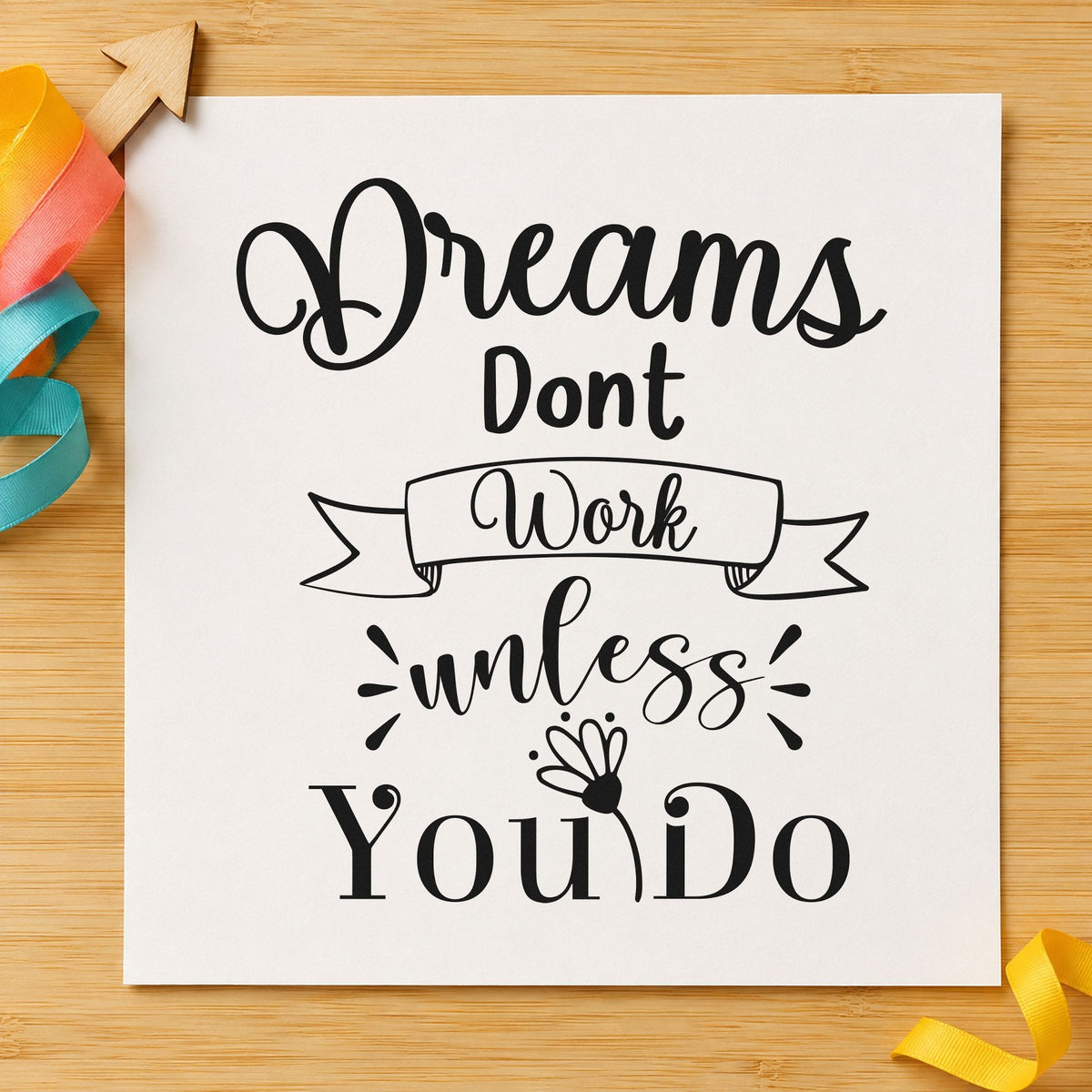 Dreams Don't Work Unless You Do craft stamp imprint in black ink on a handmade project, one idea being first order gift tags.