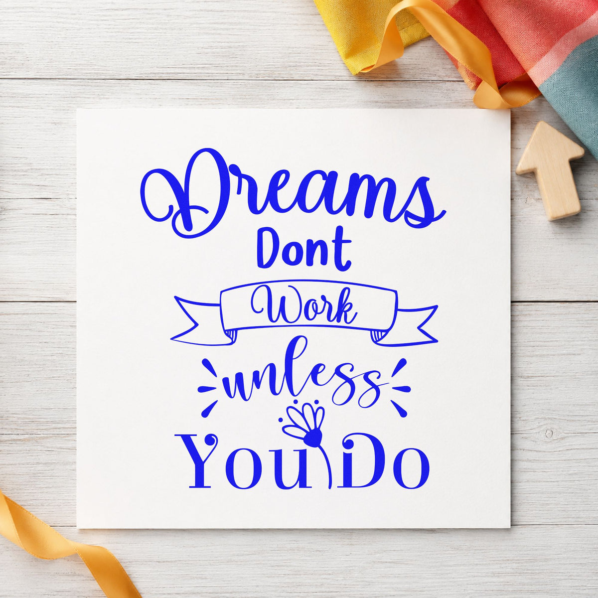 Dreams Don't Work Unless You Do craft stamp in blue ink on cardstock, an easy option for shipping tote printing.