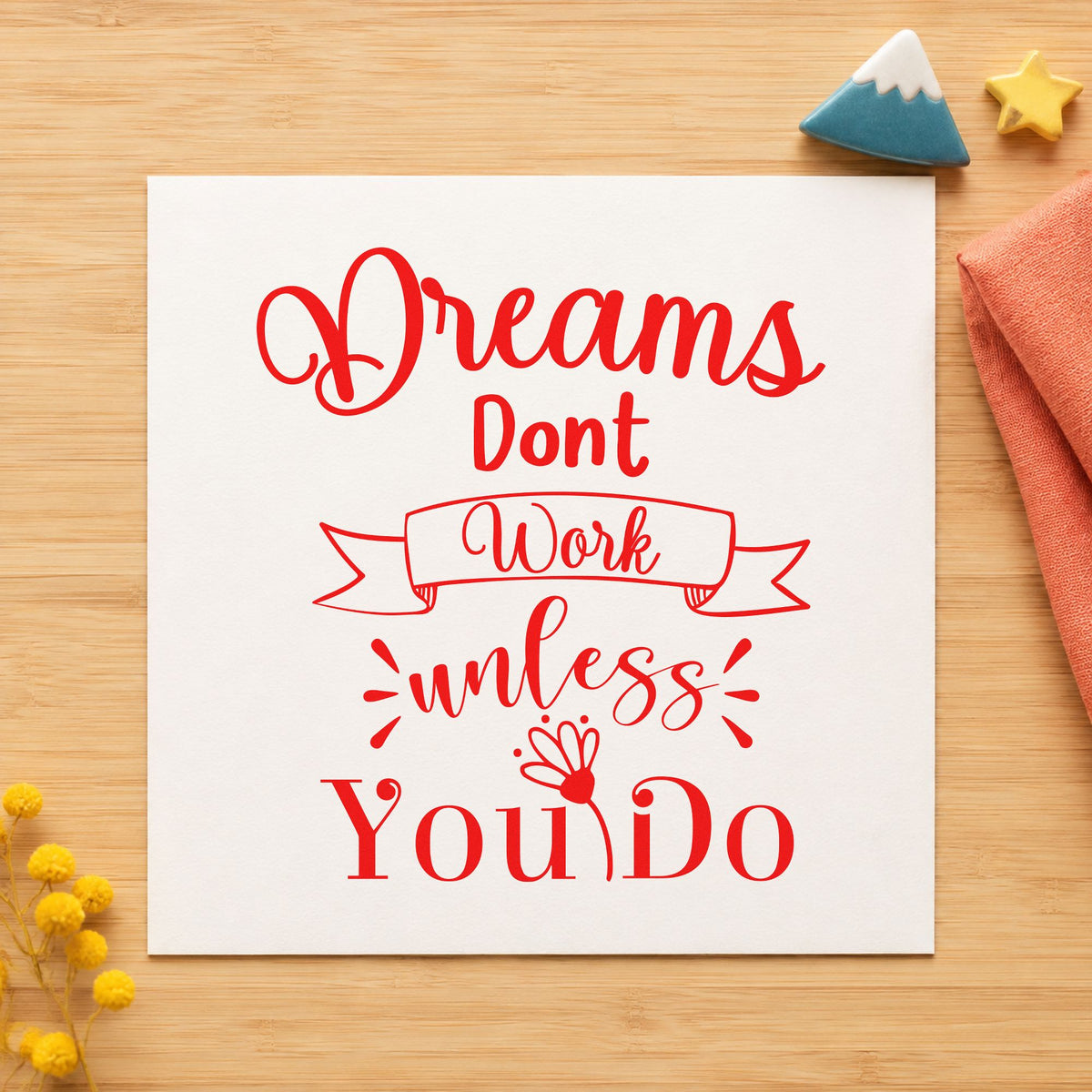 Dreams Don't Work Unless You Do craft stamp imprint in red ink on a handmade project, one idea being goal review cards.