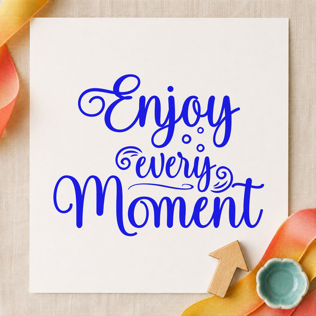 Enjoy Every Moment Flourishes craft stamp in blue ink on cardstock, an easy option for ring pillow printing.