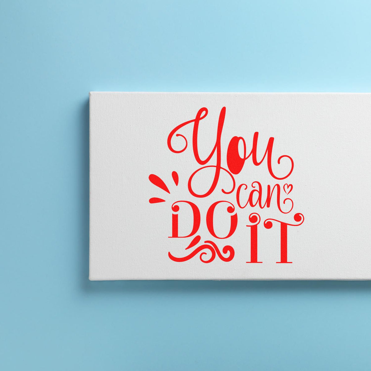 Red You can DO it rubber stamp design on a white seal block against a light blue background.
