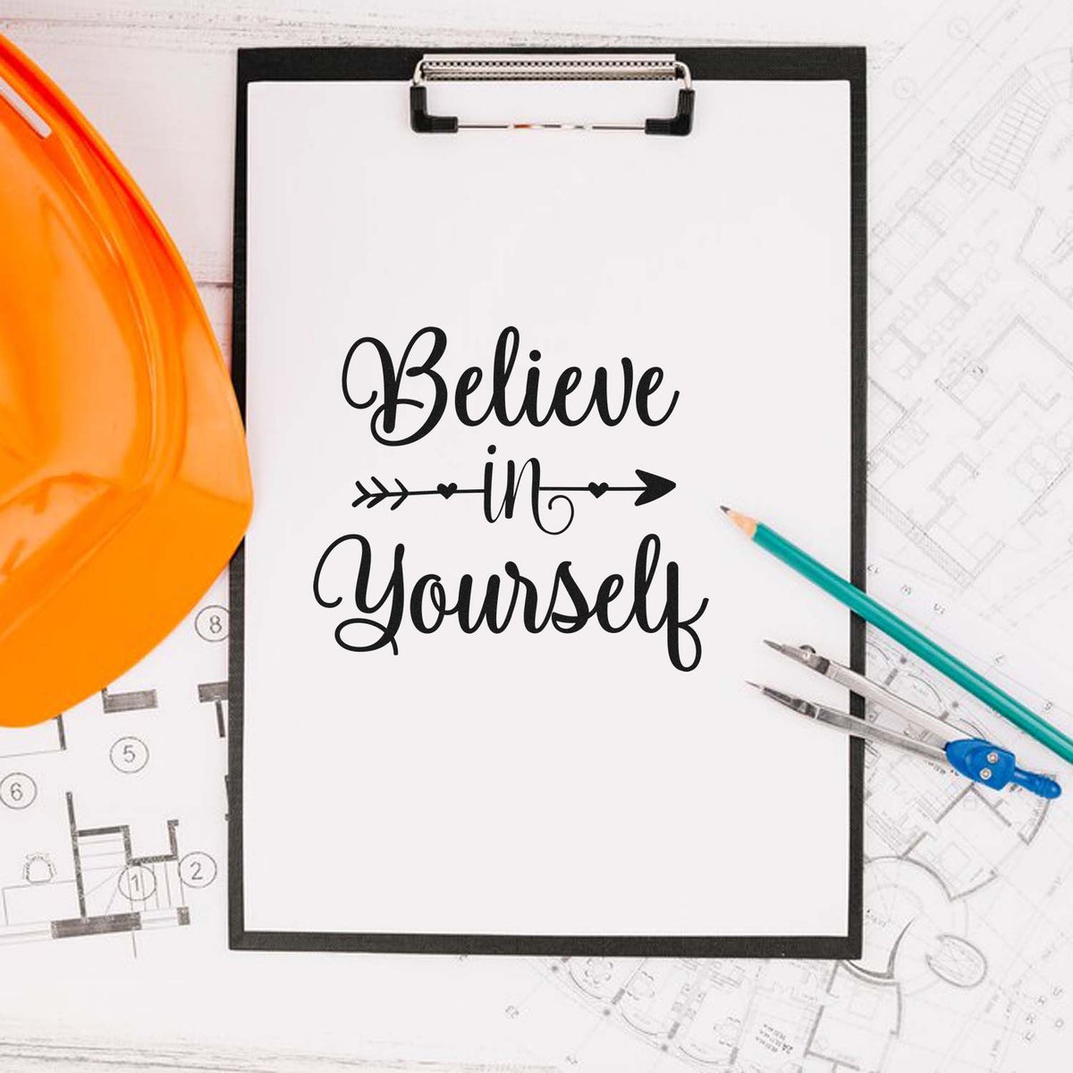 Custom stamp and seal design with black Believe in Yourself text on clipboard, orange hard hat, pencils, and blueprint background.