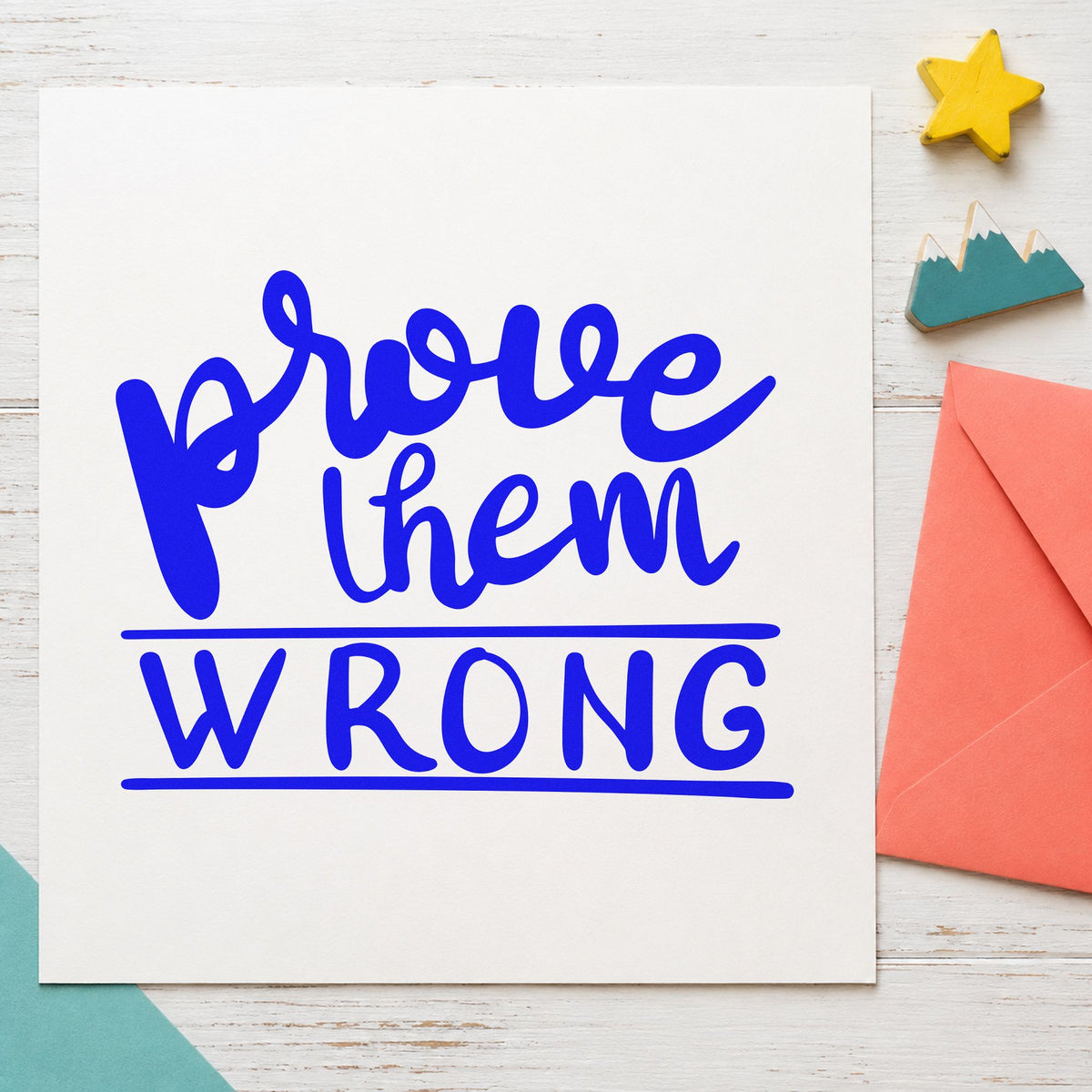 Prove Them Wrong Bold craft stamp imprinted in blue ink on paper, a design suited to framed desk corner.