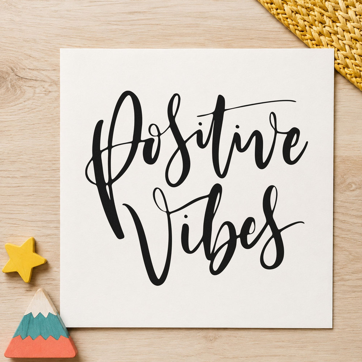 Positive Vibes Brush Script craft stamp imprint in black ink on a handmade project, one idea being board wax gift tags.