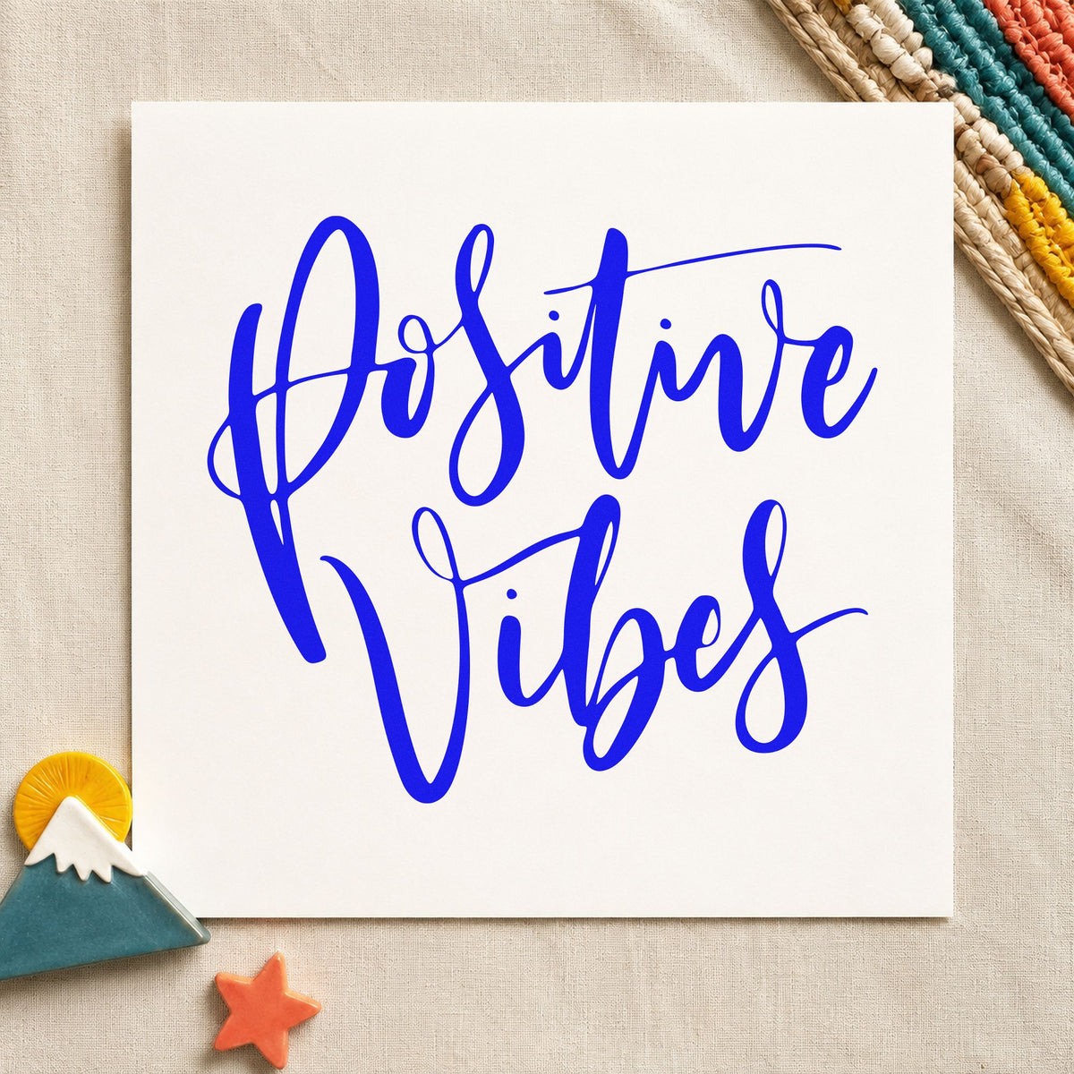 Positive Vibes Brush Script craft stamp in blue ink on cardstock, an easy option for board bag printing.