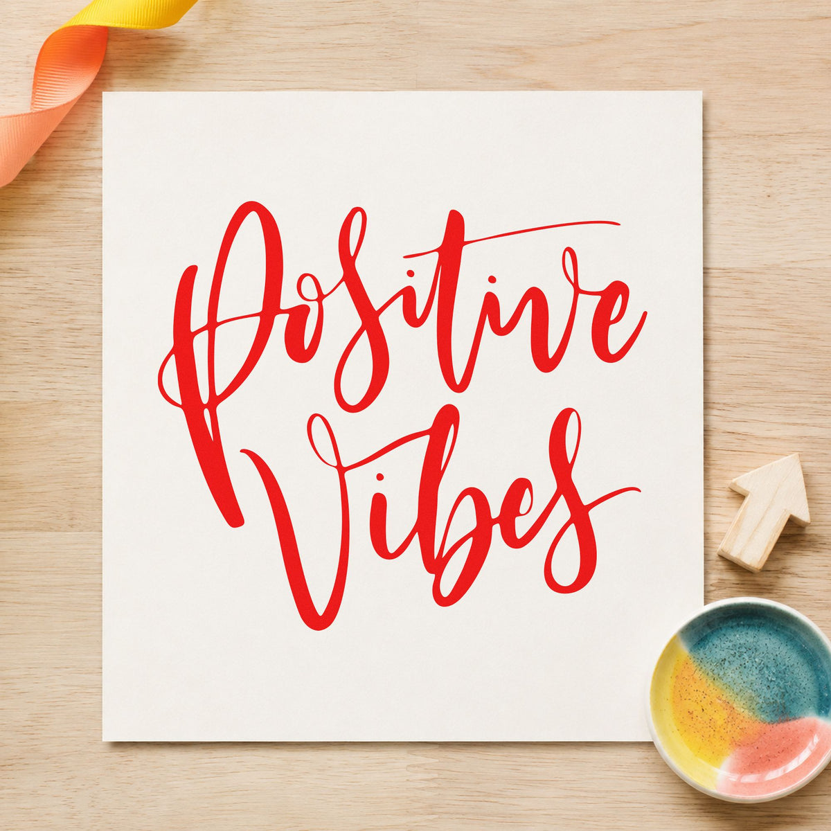 Positive Vibes Brush Script craft stamp imprint in red ink on a handmade project, one idea being session note cards.