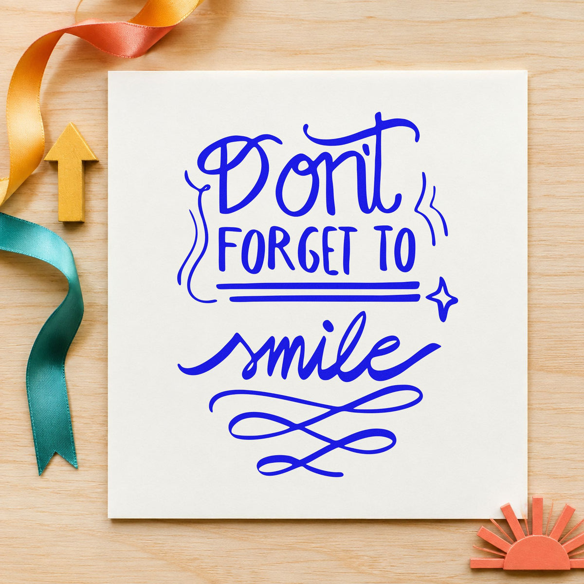 Don't Forget To Smile craft stamp imprinted in blue ink on paper, a design suited to framed waiting room.