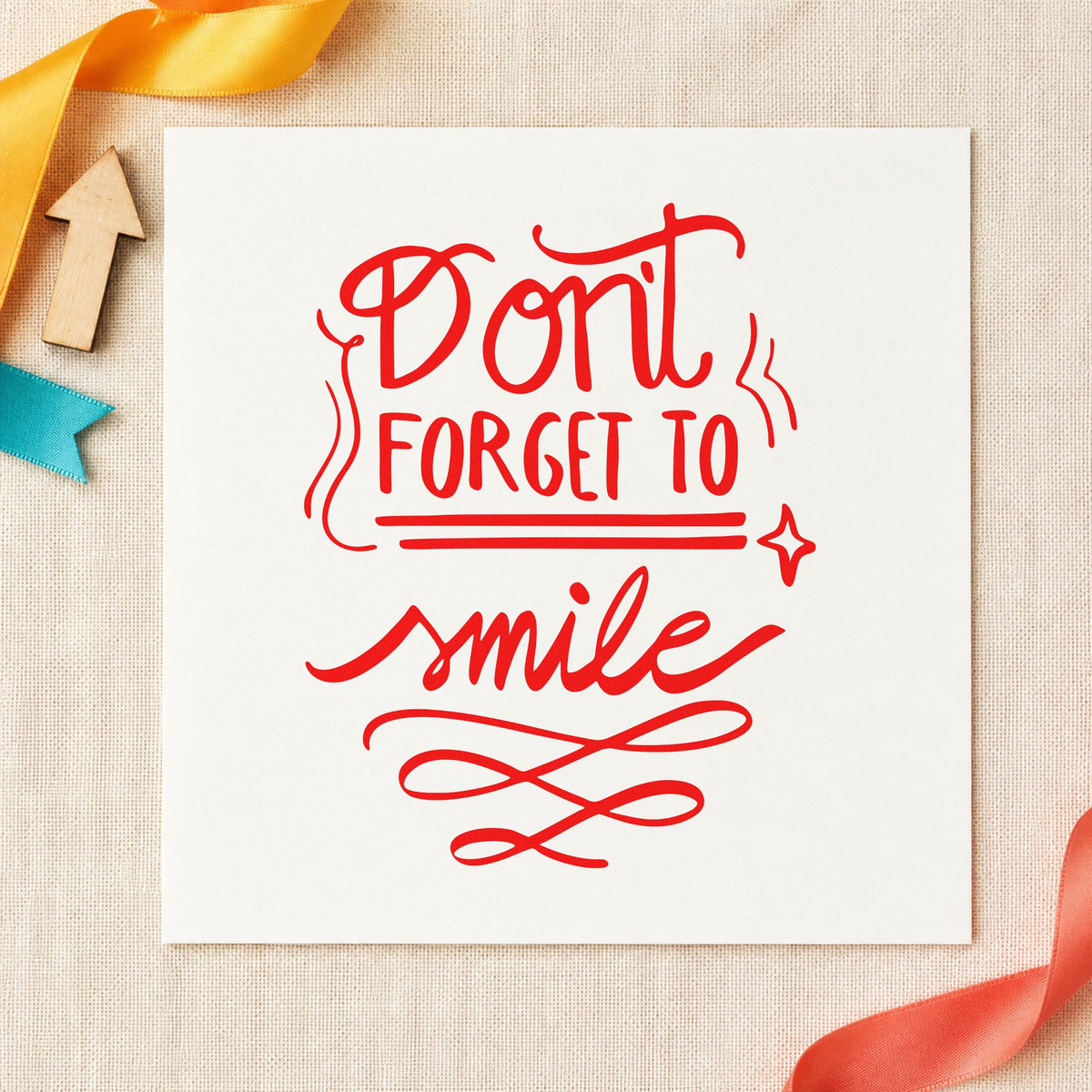Don't Forget To Smile craft stamp imprint in red ink on a handmade project, one idea being appointment cards.