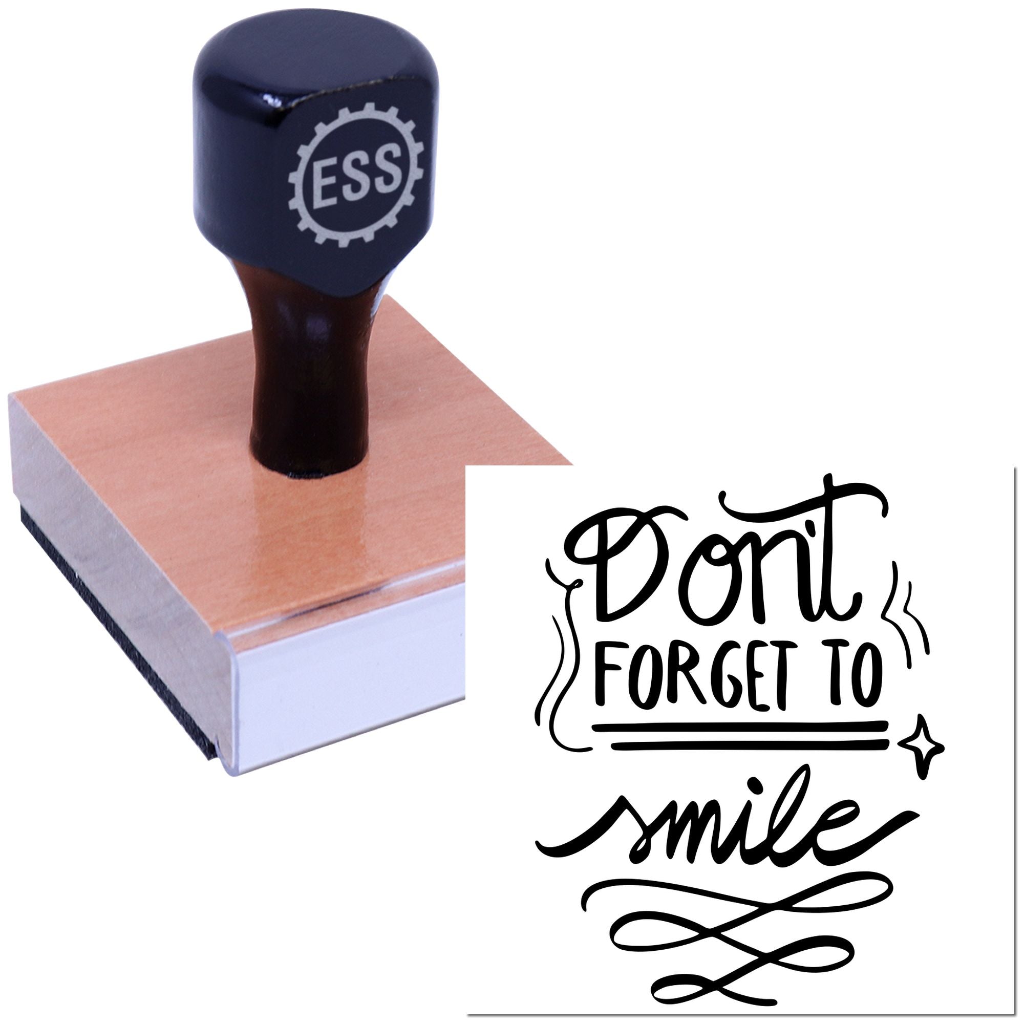 Black self-inking stamp with ESS logo on a pink block beside a decorative black Dont forget to smile seal.