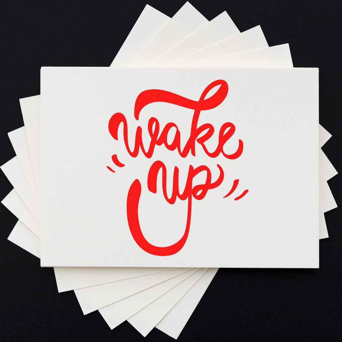 White stamp and seal sample cards with bold red Wake Up lettering on a black background.
