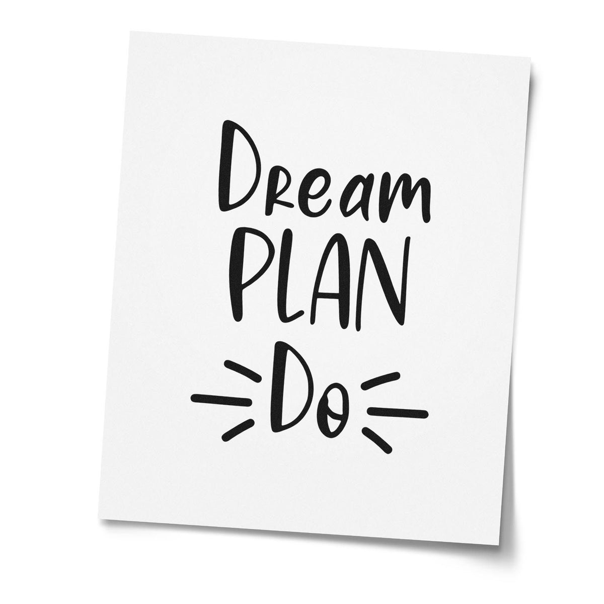 White custom stamp seal with black Dream Plan Do lettering and radiating lines.