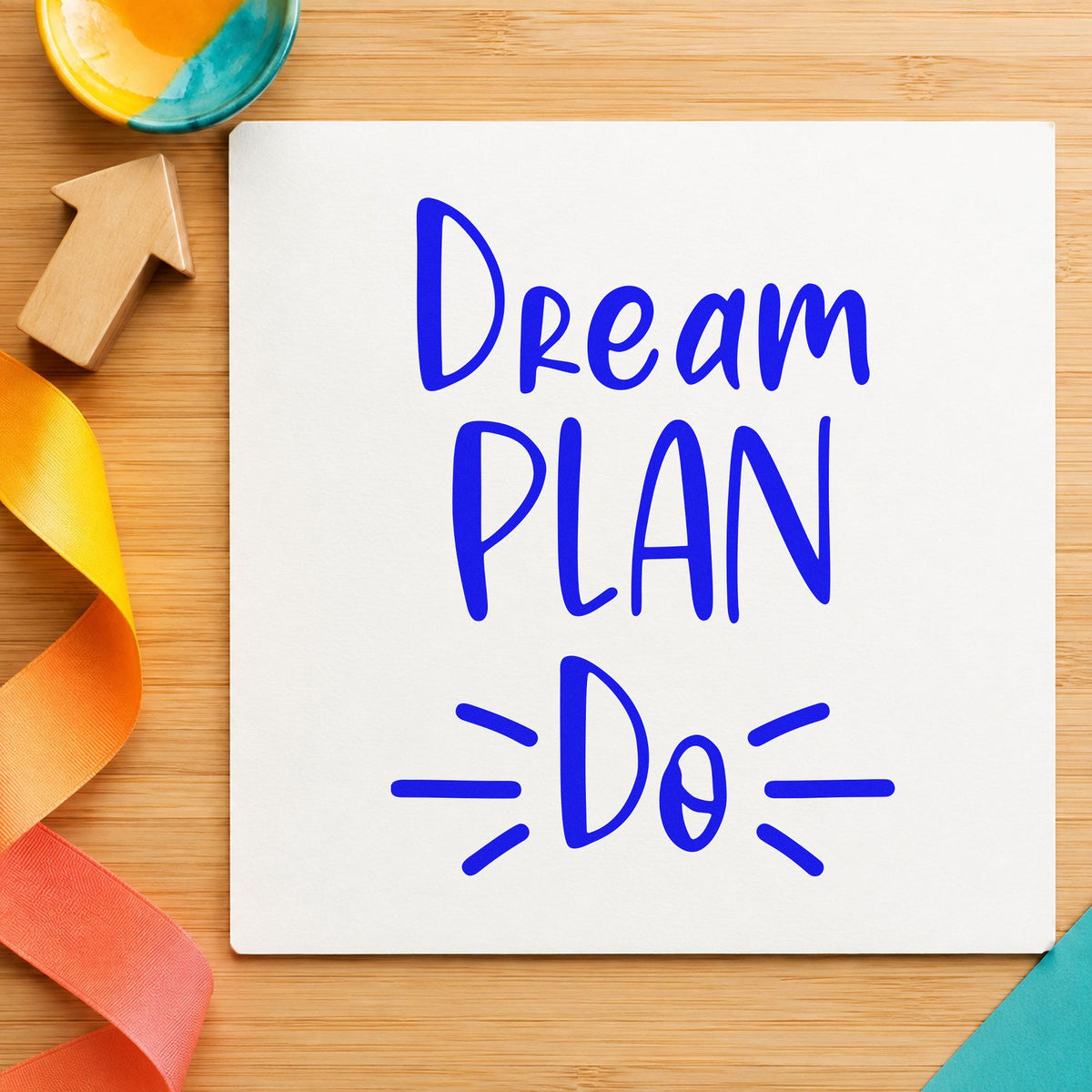 Dream Plan Do Lettering craft stamp imprinted in blue ink on paper, a design suited to framed hall closet.