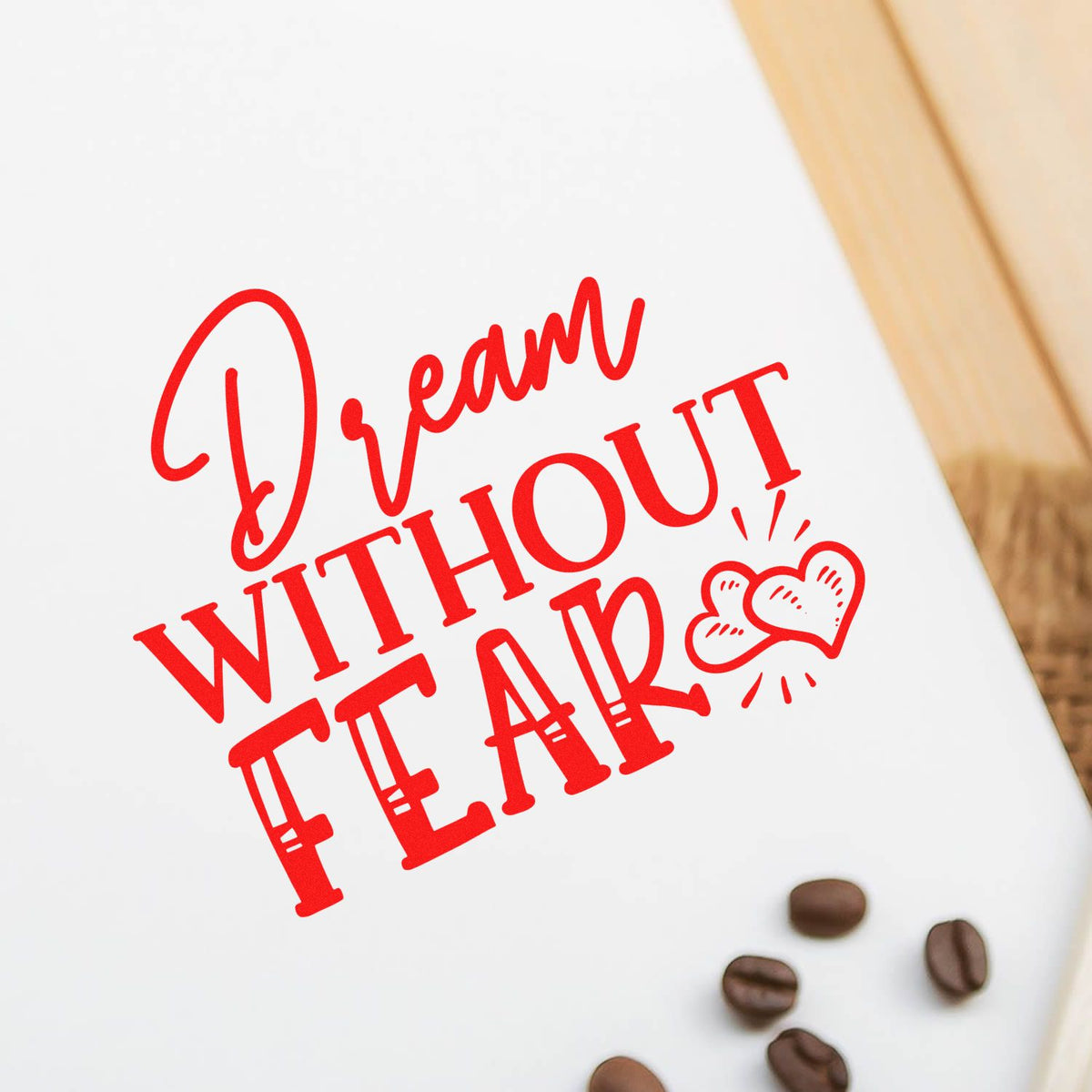 Red Dream Without Fear stamp-style seal on white background with heart accents and coffee beans