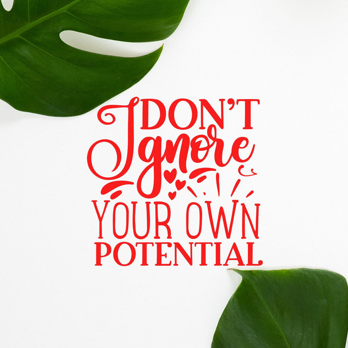 Red motivational stamp seal reading Dont Ignore Your Own Potential on white, framed by green leaves and heart accents.