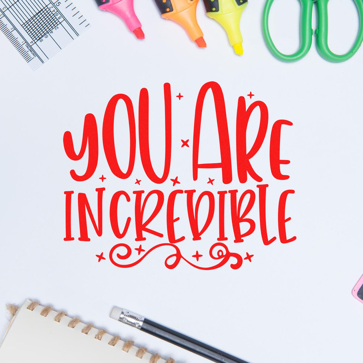 Red YOU ARE INCREDIBLE stamp and seal design on white, framed by pink, orange, yellow highlighters and stationery.