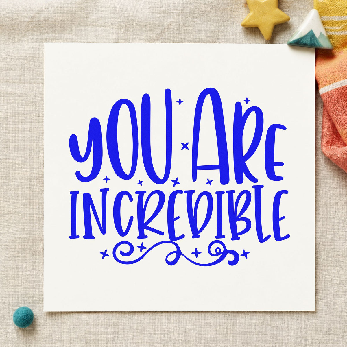 You Are Incredible Flourishes craft stamp in blue ink on cardstock, an easy option for book bag printing.