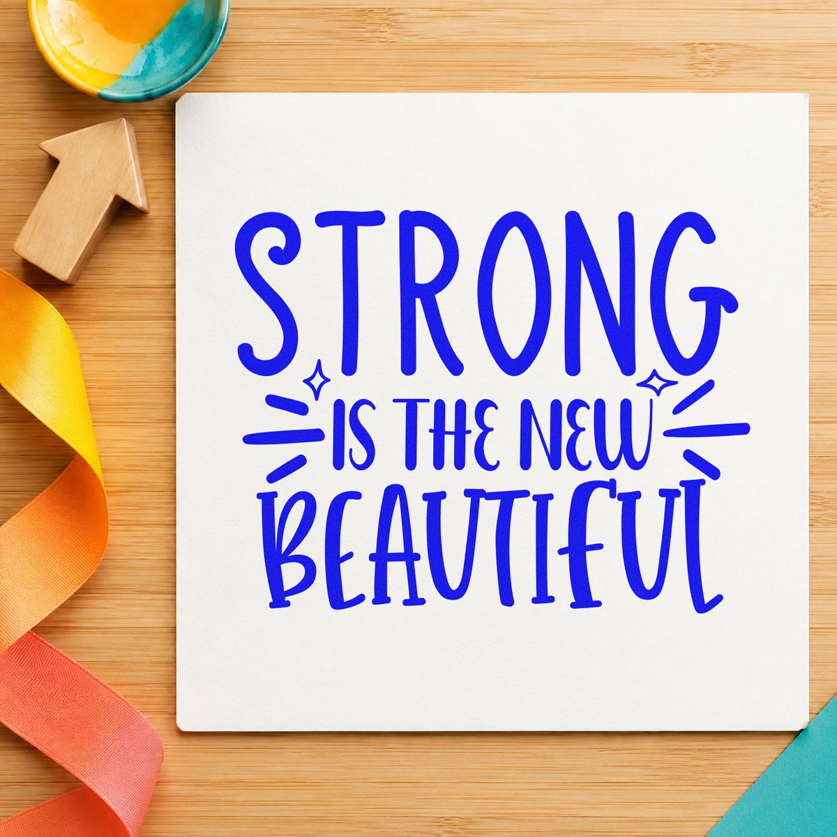 Strong New Beautiful Lettering craft stamp imprinted in blue ink on paper, a design suited to framed boathouse door.