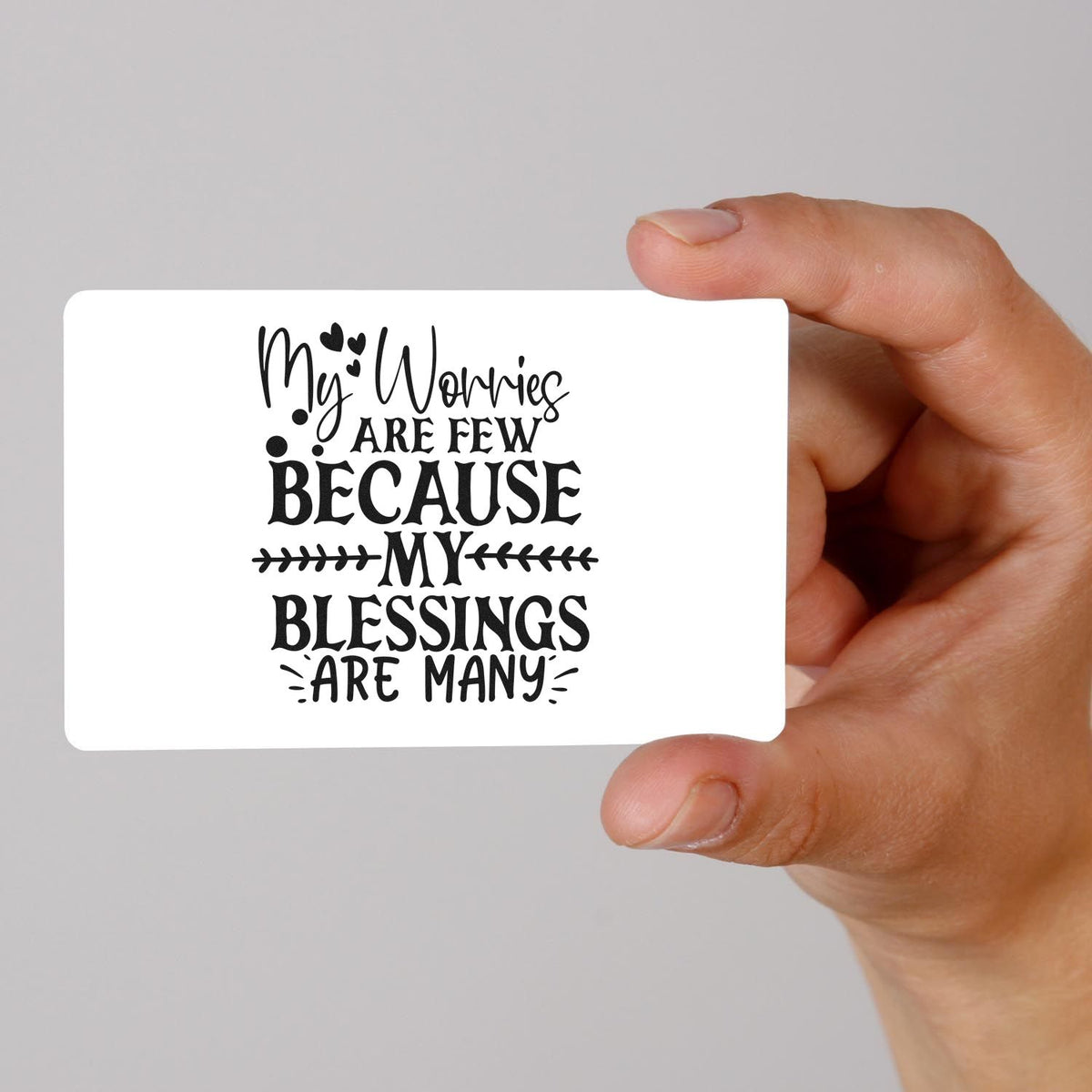 Hand holding white custom stamp card with black quote My worries are few because my blessings are many and heart accents.