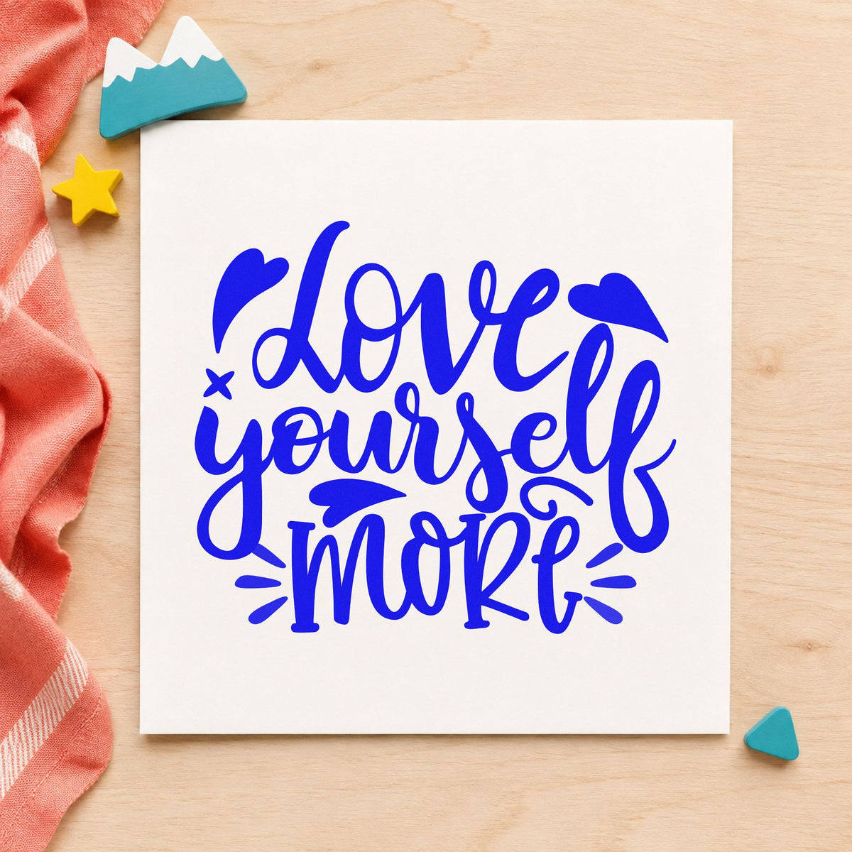 Love Yourself More Hearts craft stamp in blue ink on cardstock, an easy option for mat bag printing.