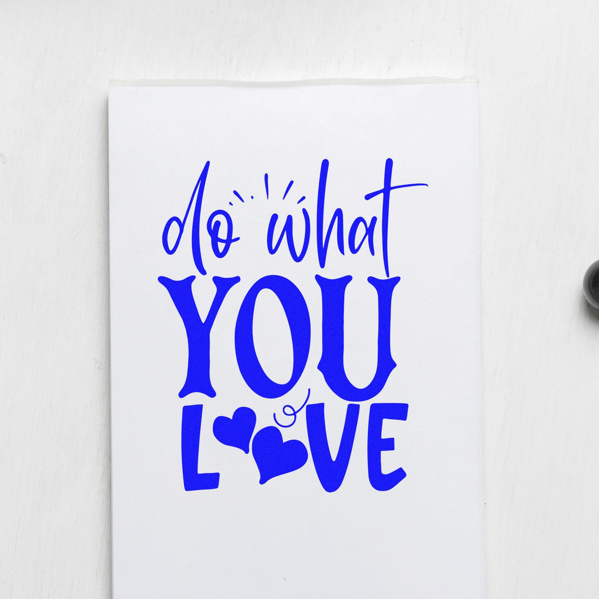 Blue do what YOU LOVE stamp and seal design with heart accents on white paper.