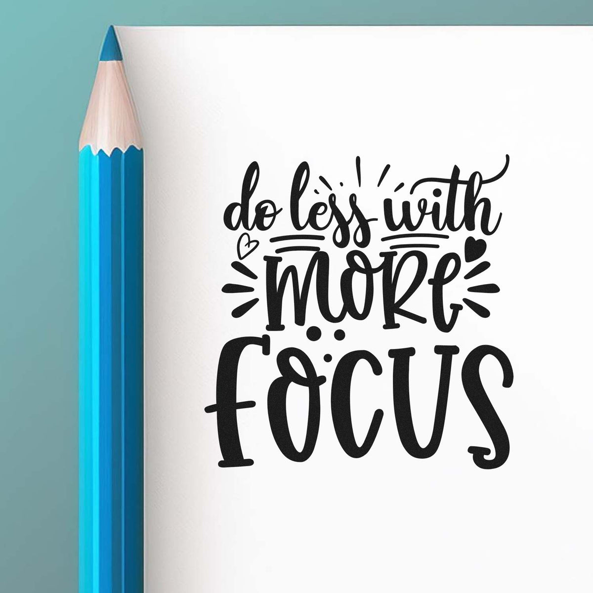 Black motivational stamp/seal design reading do less with more focus beside a teal pencil on a white background.