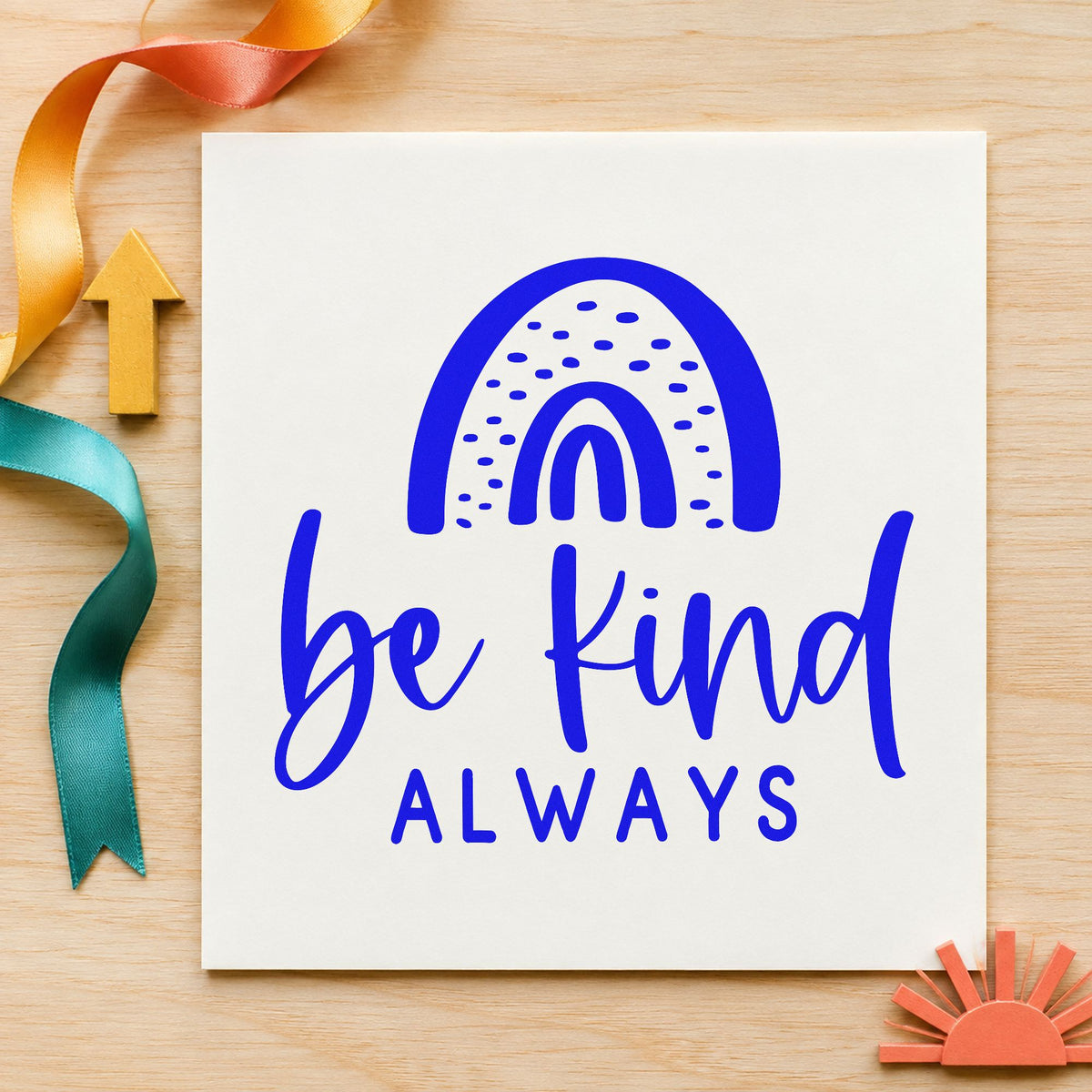 Be Kind Always Rainbow craft stamp in blue ink on cardstock, an easy option for nap blanket printing.