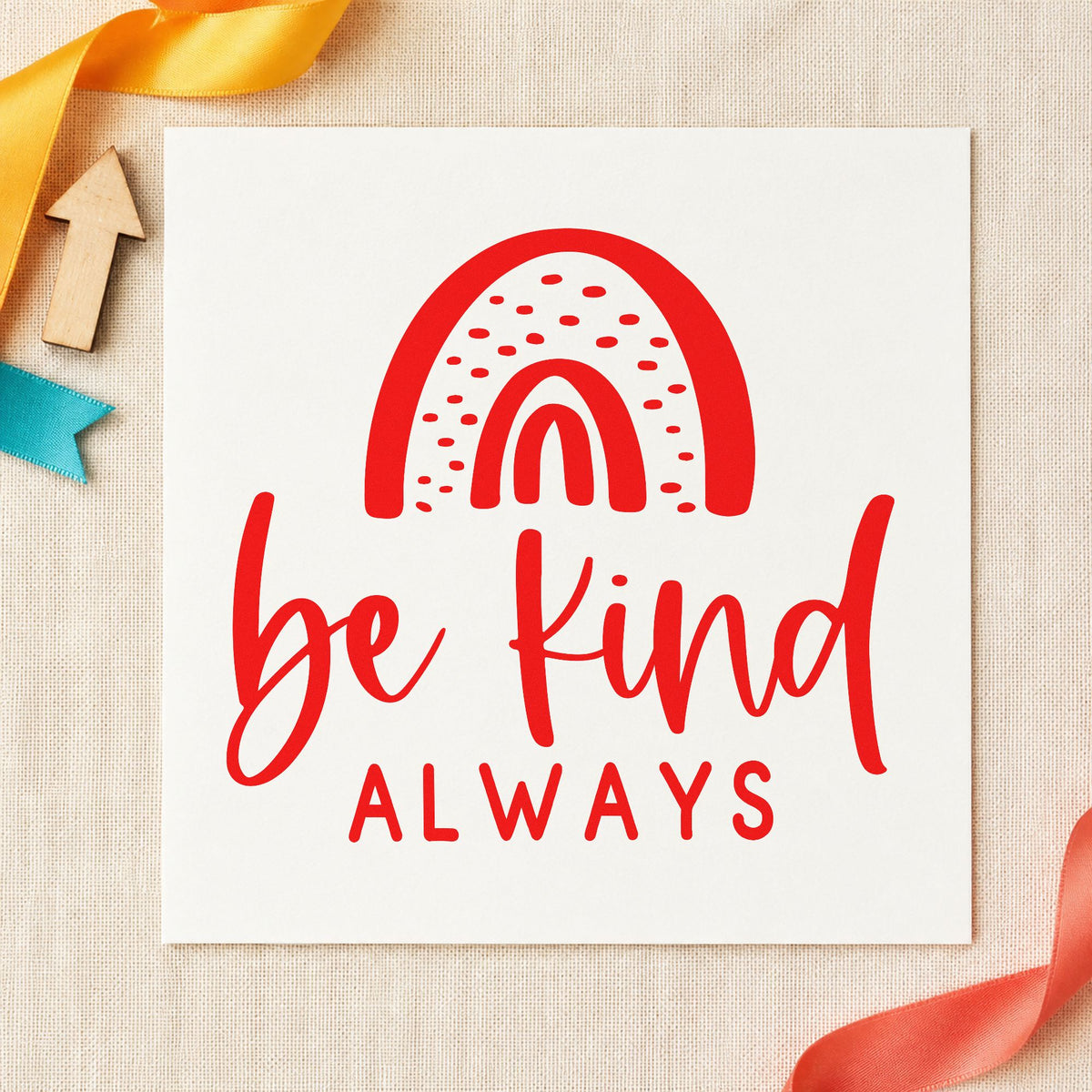 Be Kind Always Rainbow rubber stamp shown in red ink, stamped for projects such as cubby photo labels.