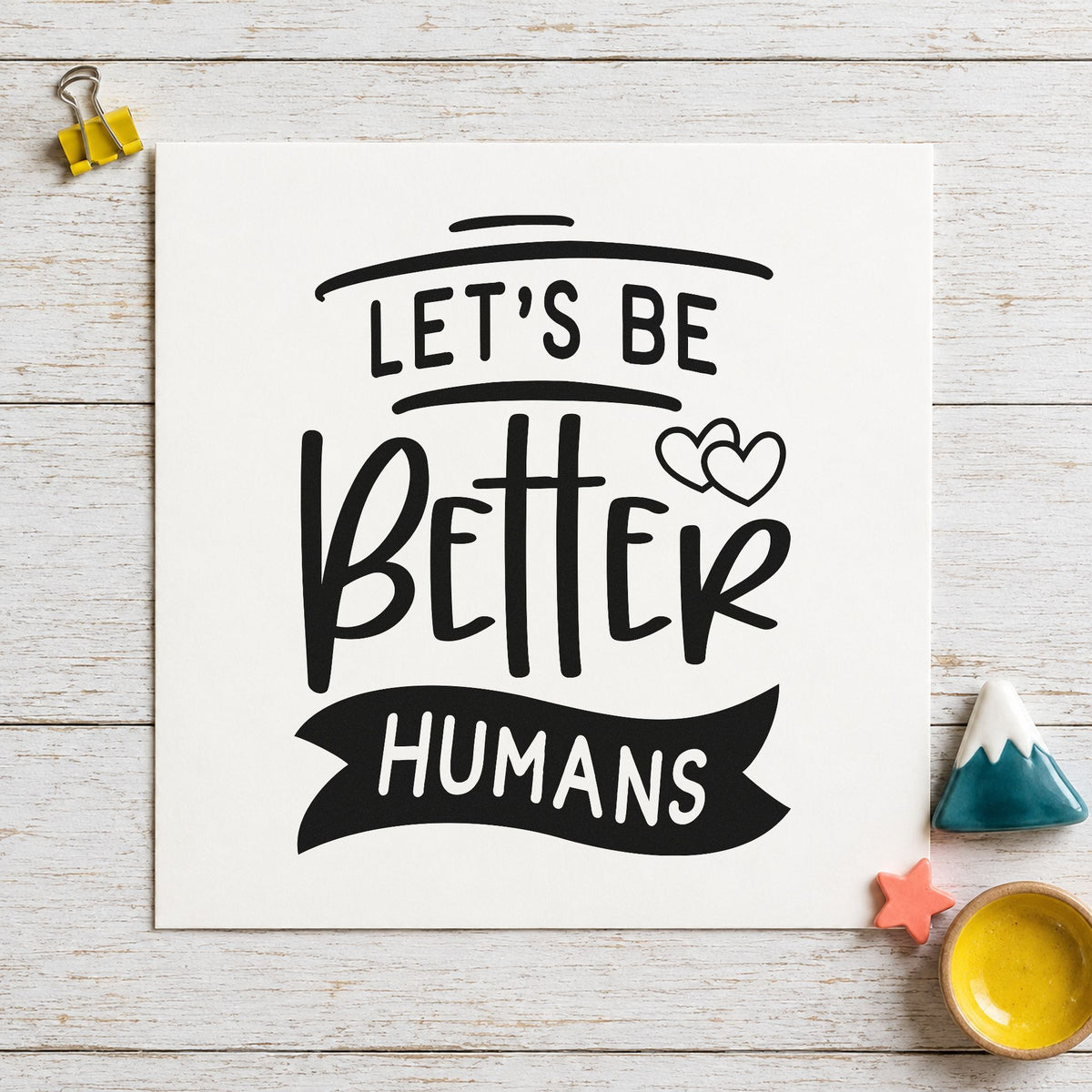 Let's Be Better Humans craft stamp imprint in black ink on a handmade project, one idea being welcome kit gift tags.
