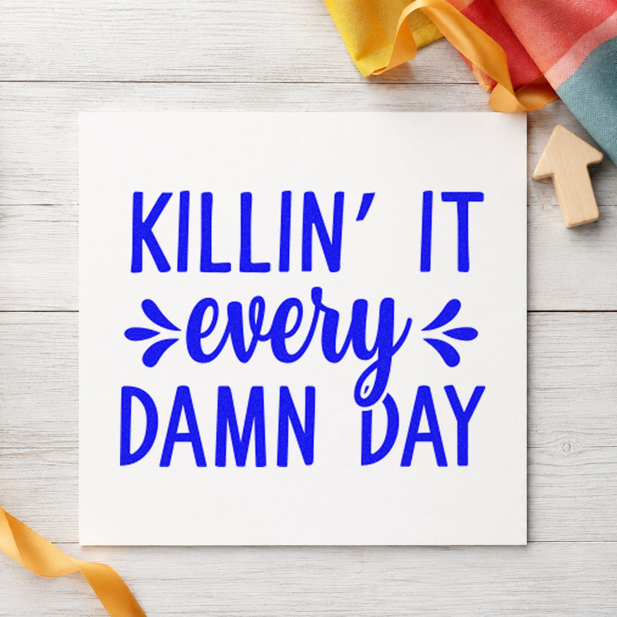 Killin It Every Damn Day craft stamp in blue ink on cardstock, an easy option for studio apron printing.
