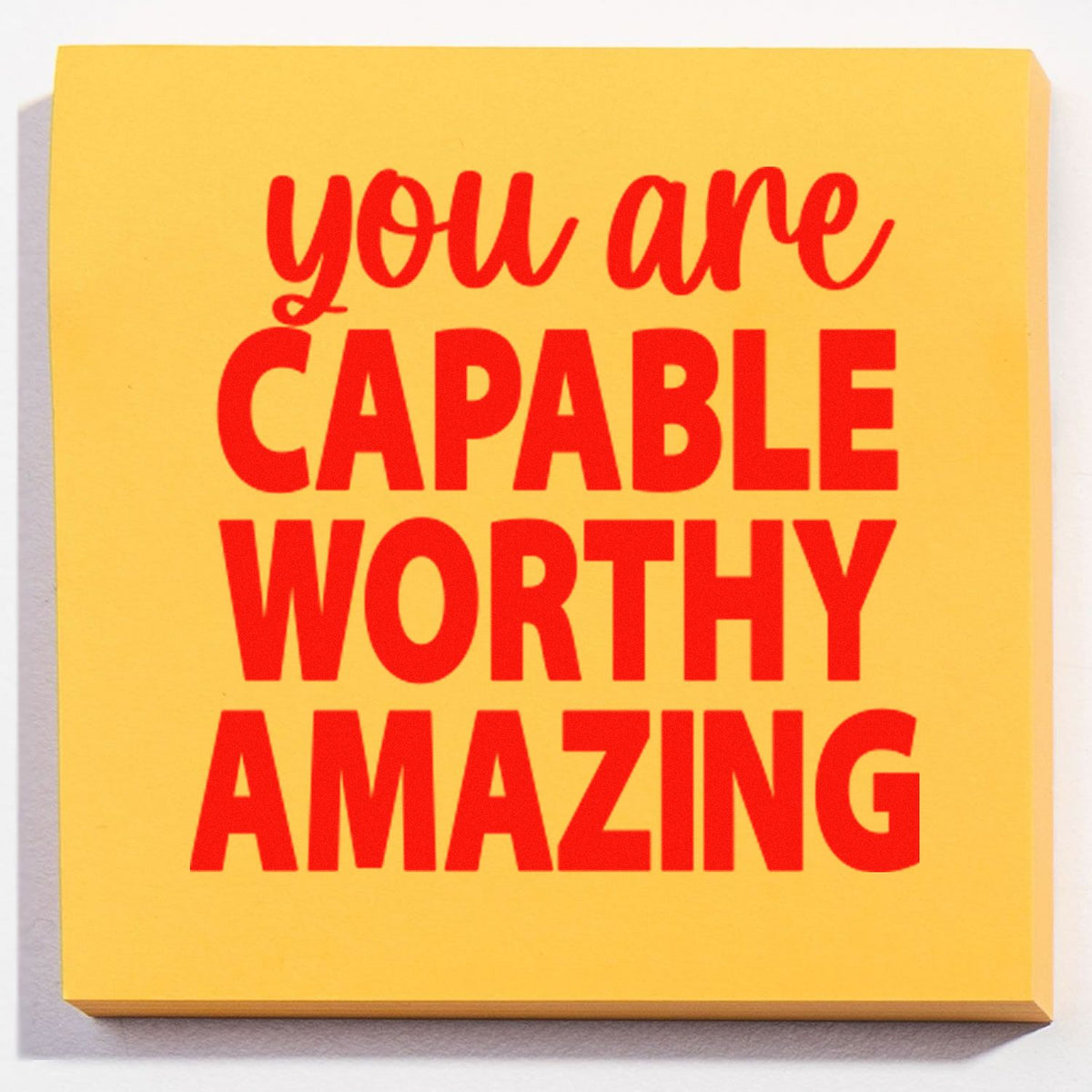 Yellow self-inking stamp seal with red you are capable, worthy, amazing motivational text.